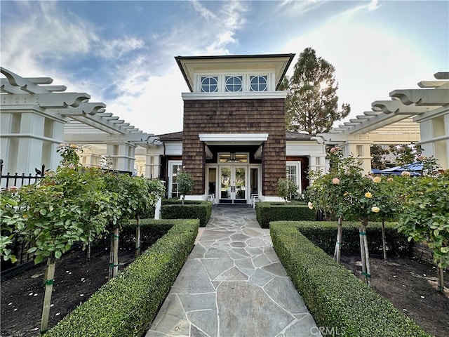 exterior space featuring french doors and a pergola