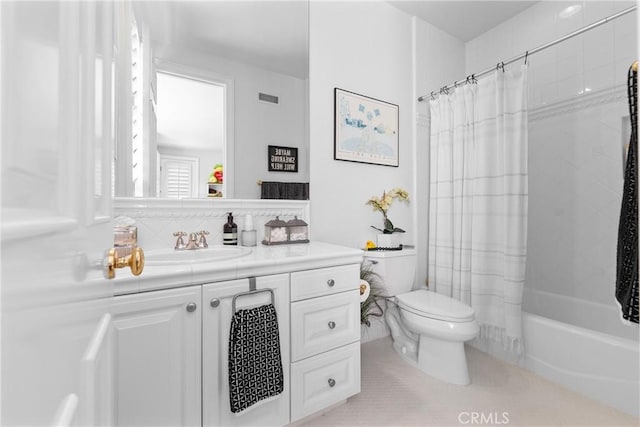 full bathroom with vanity, toilet, and shower / bath combo with shower curtain