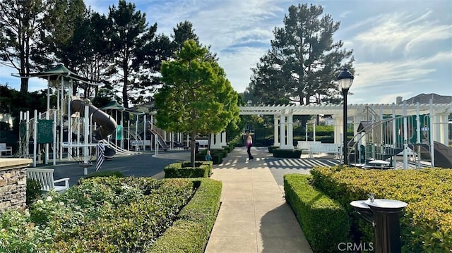 view of property's community featuring a pergola and playground community