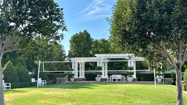 view of community with a pergola and a lawn