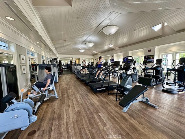 exercise room featuring lofted ceiling, wood finished floors, and wood ceiling