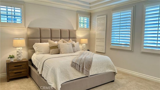 bedroom with ornamental molding, light carpet, and baseboards