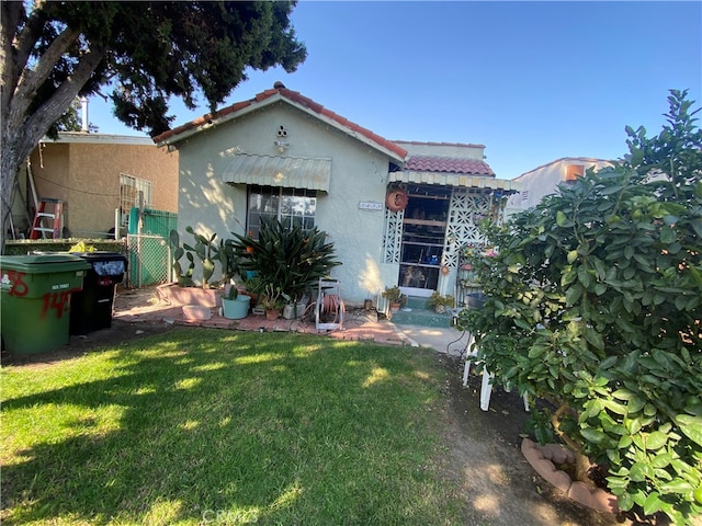 rear view of house with a yard