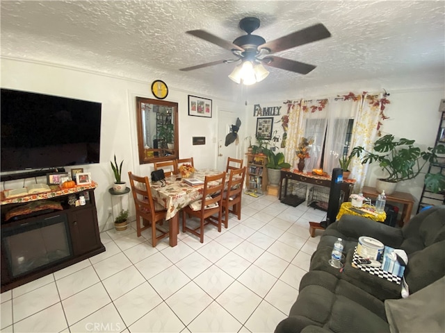 dining room featuring a textured ceiling, light tile patterned floors, and ceiling fan