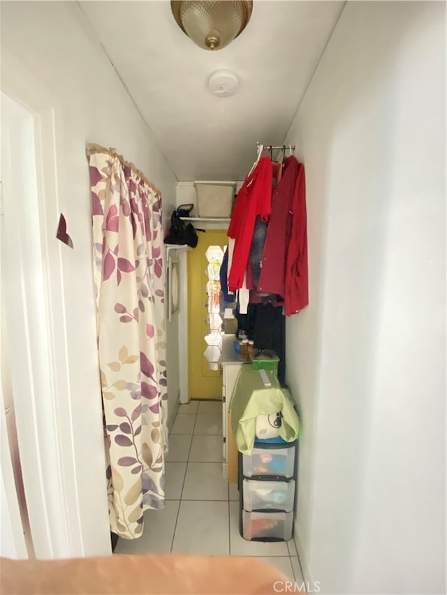 spacious closet with light tile patterned floors