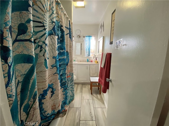 bathroom featuring vanity and a shower with curtain