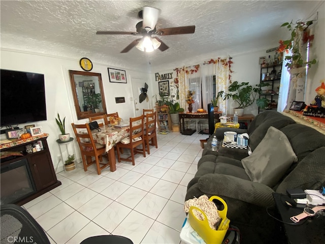 tiled living room featuring a textured ceiling and ceiling fan