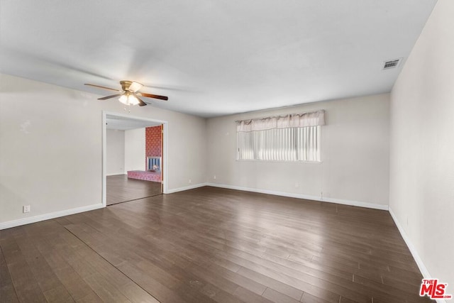 spare room featuring ceiling fan and dark hardwood / wood-style flooring