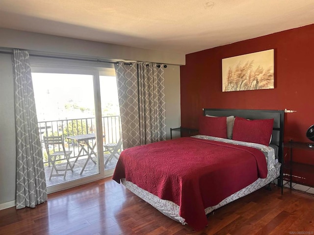 bedroom with hardwood / wood-style flooring and access to outside