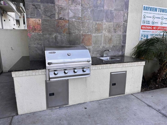 view of patio / terrace with area for grilling and sink