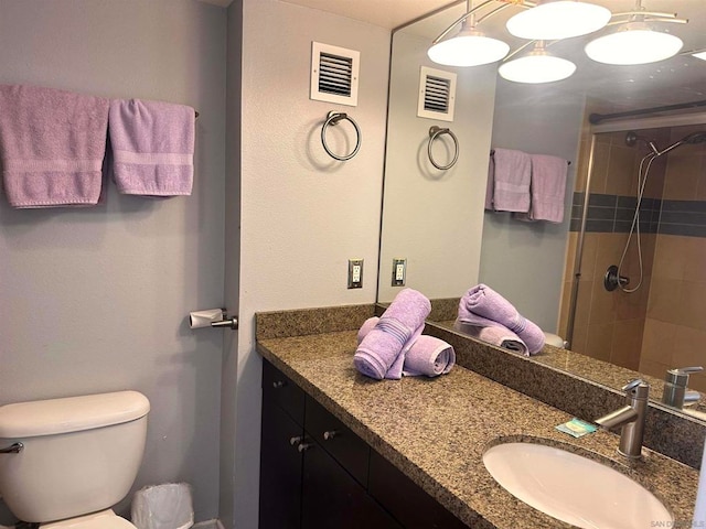 bathroom with walk in shower, vanity, and toilet