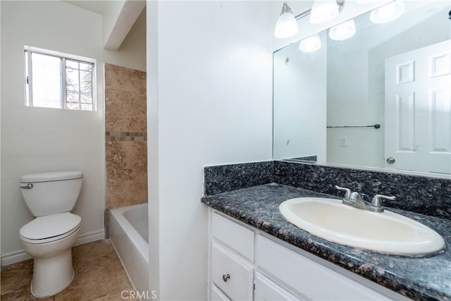 bathroom with tile patterned flooring, vanity, and toilet