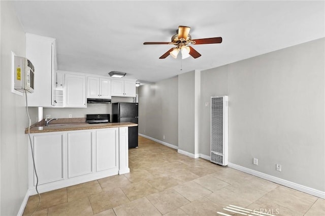 kitchen with kitchen peninsula, ceiling fan, sink, black appliances, and white cabinetry