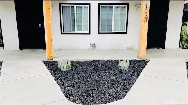 view of exterior entry featuring a porch