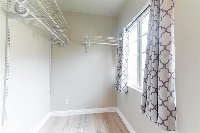 spacious closet with light hardwood / wood-style flooring