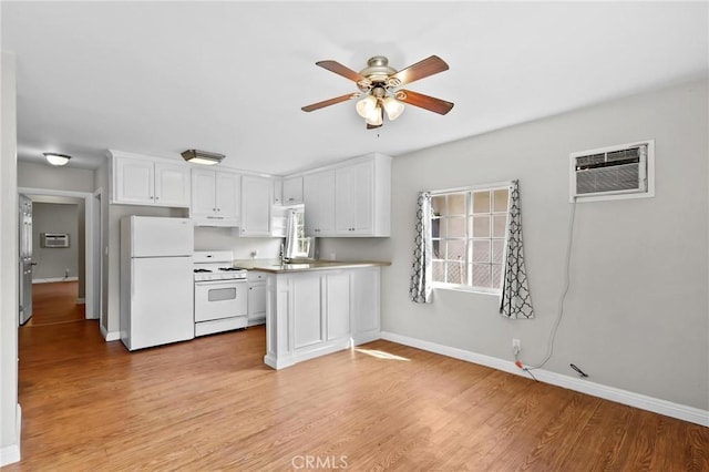 kitchen featuring white cabinetry, ceiling fan, light hardwood / wood-style flooring, an AC wall unit, and white appliances