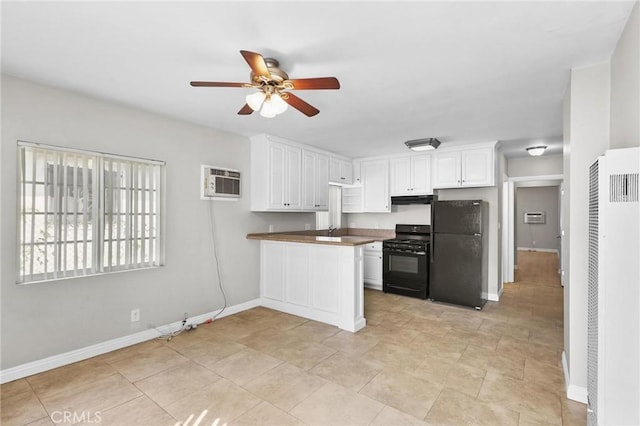 kitchen featuring ceiling fan, a wall unit AC, kitchen peninsula, white cabinets, and black appliances