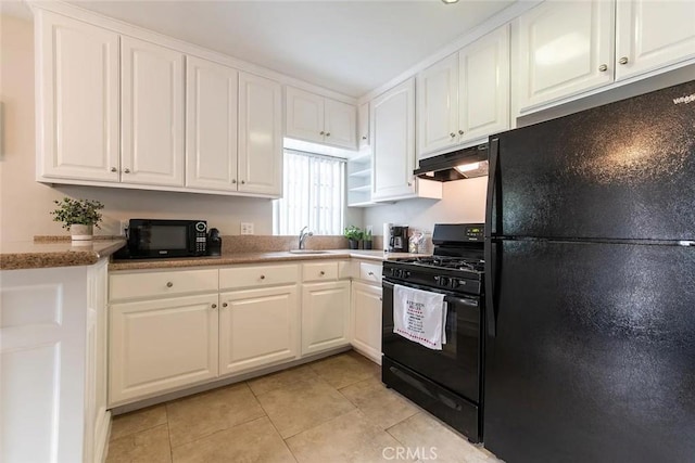 kitchen with black appliances, light tile patterned flooring, white cabinetry, and sink