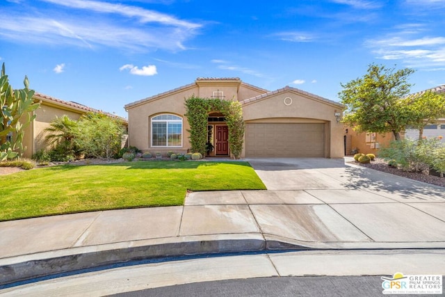 mediterranean / spanish-style home with a garage and a front lawn