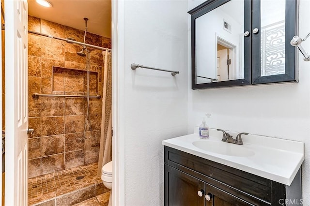 bathroom with vanity, curtained shower, and toilet