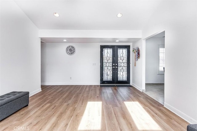 entryway featuring light hardwood / wood-style flooring and french doors