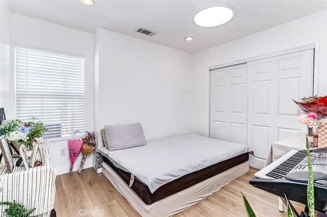 bedroom featuring a closet and light hardwood / wood-style flooring