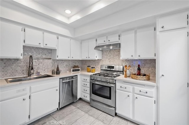 kitchen with stainless steel appliances, white cabinetry, and sink