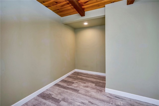 unfurnished room with wood ceiling, light wood-type flooring, and beamed ceiling