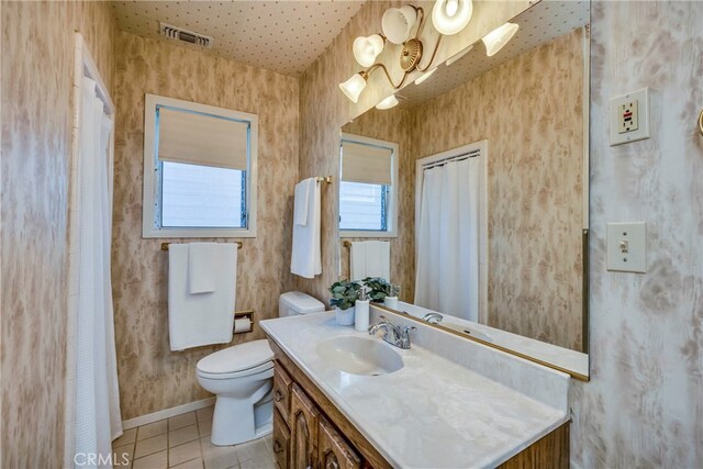 bathroom featuring vanity, tile patterned flooring, and toilet