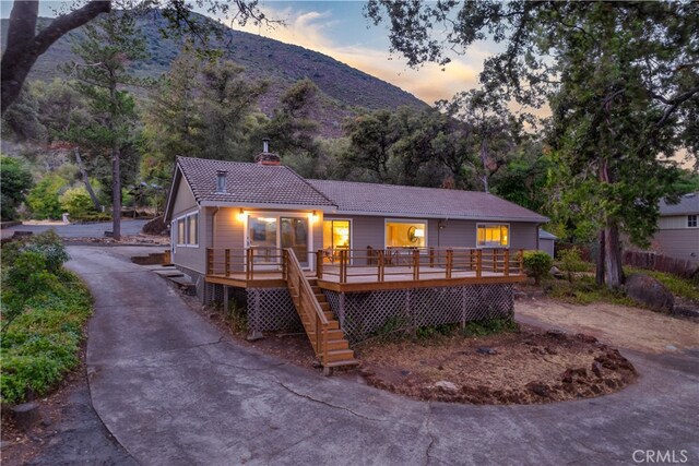 view of front of house featuring a deck with mountain view