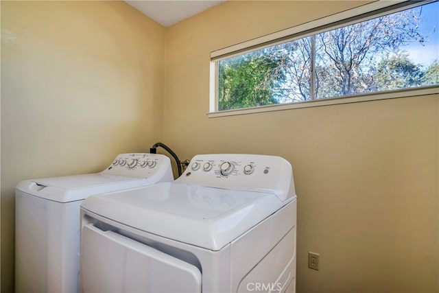 clothes washing area featuring washing machine and clothes dryer