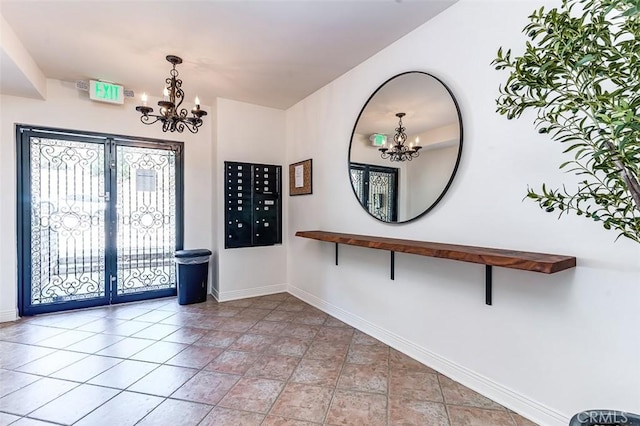 entryway featuring a mail area and a chandelier