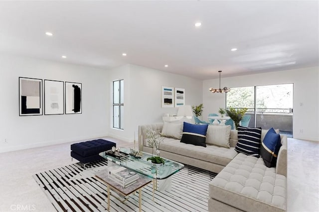 carpeted living room with a notable chandelier