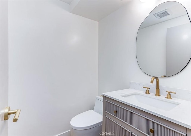 bathroom featuring vanity and toilet