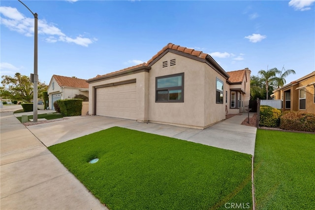 mediterranean / spanish house featuring a front yard and a garage