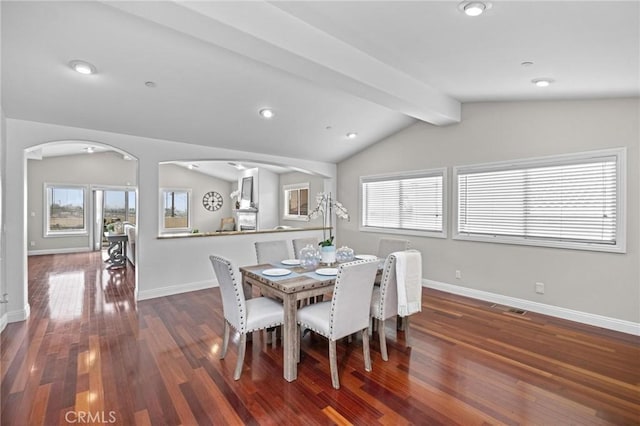 dining room featuring dark hardwood / wood-style flooring and vaulted ceiling with beams