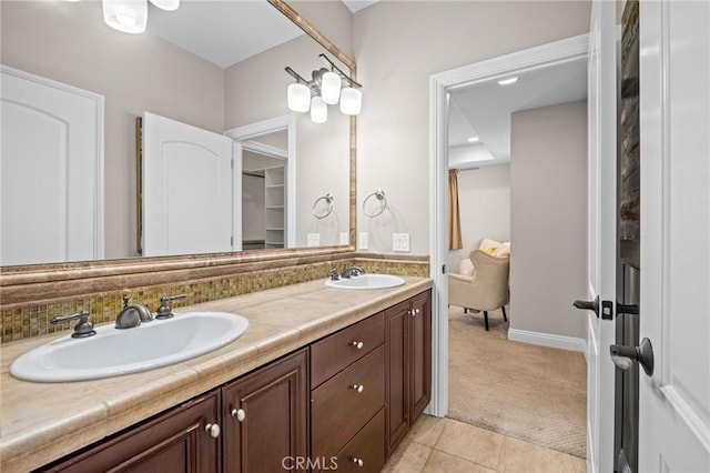 bathroom featuring vanity, tile patterned flooring, and decorative backsplash