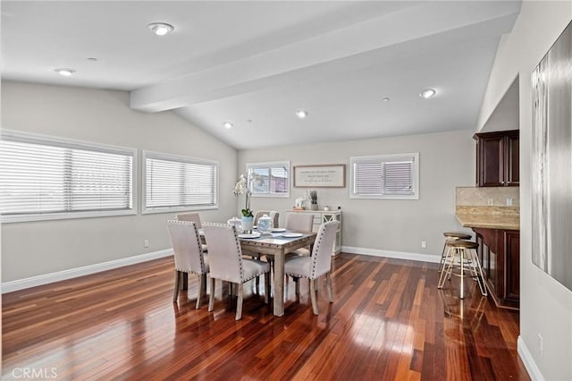 dining space with dark hardwood / wood-style flooring and vaulted ceiling with beams