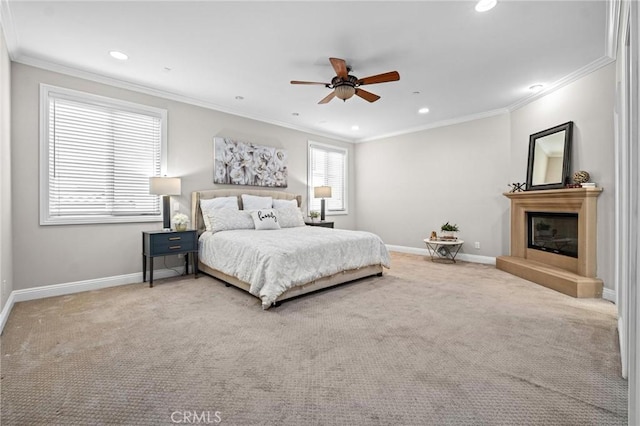 carpeted bedroom with ceiling fan and ornamental molding