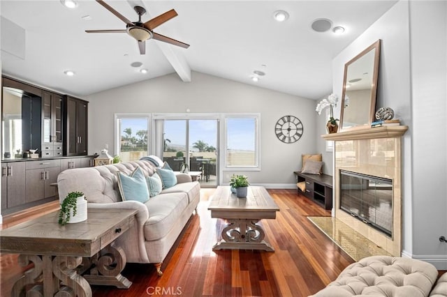 living room featuring a high end fireplace, lofted ceiling with beams, dark hardwood / wood-style floors, and ceiling fan