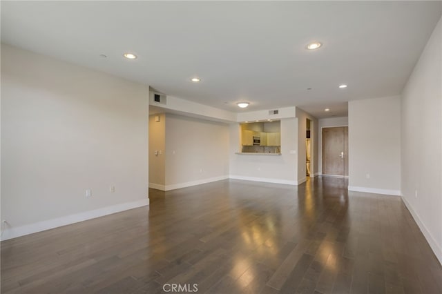 unfurnished living room with dark hardwood / wood-style flooring