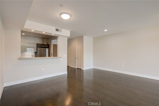 empty room with dark hardwood / wood-style flooring