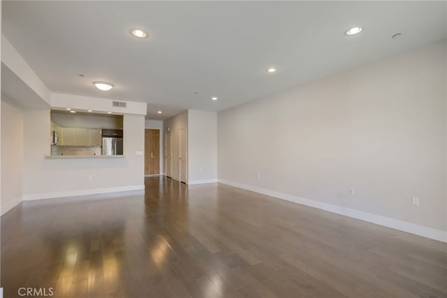 unfurnished living room featuring dark wood-type flooring