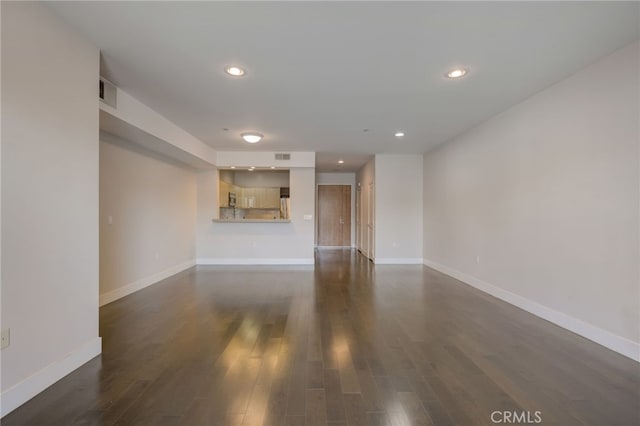 unfurnished living room featuring dark wood-type flooring