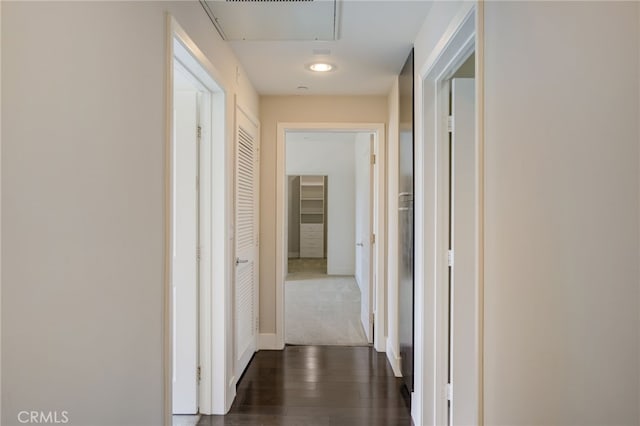 hallway with dark hardwood / wood-style floors