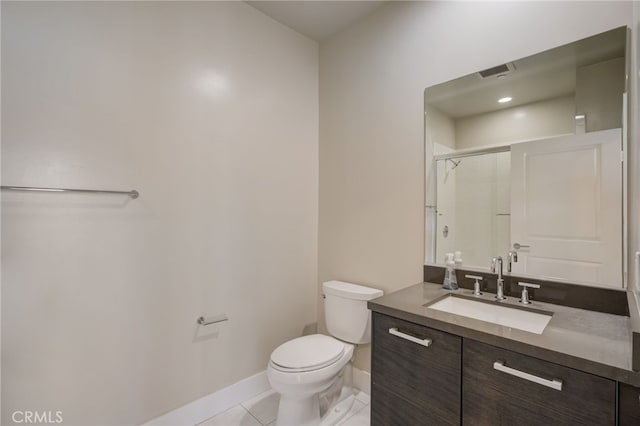 bathroom with vanity, a shower with shower door, toilet, and tile patterned floors