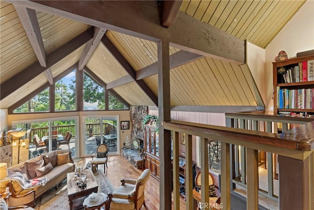 living room featuring beamed ceiling, hardwood / wood-style flooring, and high vaulted ceiling