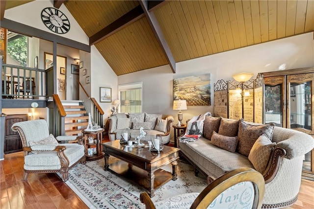 living room featuring beamed ceiling, wood-type flooring, high vaulted ceiling, and wooden ceiling