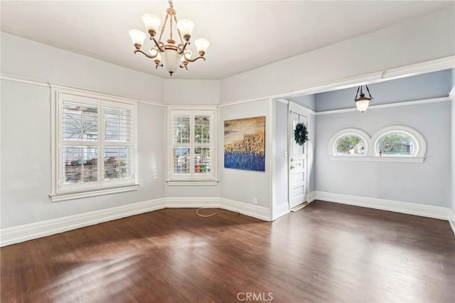 unfurnished dining area featuring dark hardwood / wood-style flooring and a notable chandelier