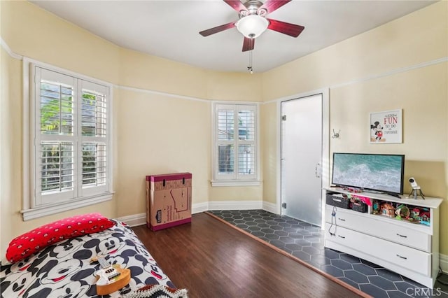 bedroom featuring dark hardwood / wood-style flooring and ceiling fan